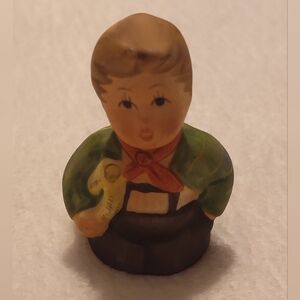 Charming Figurine with Green Coat and Red Scarf